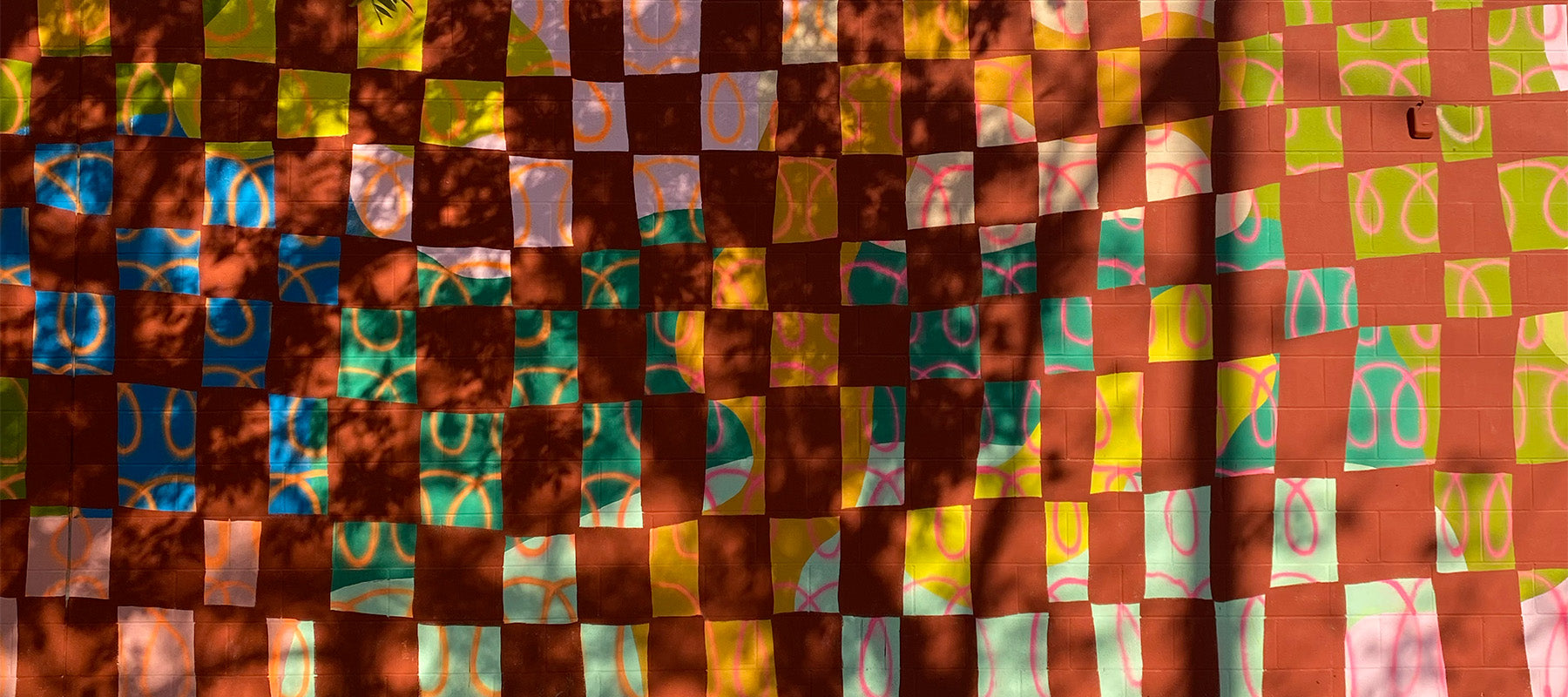 Warm toned abstract checkered outdoor mural.