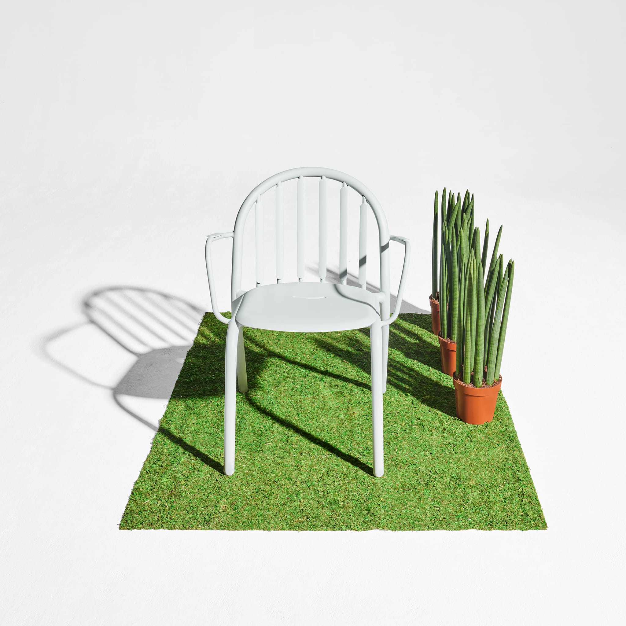 Fred’s Armchair enhancing the look of a contemporary balcony with its sleek, modern aesthetic.