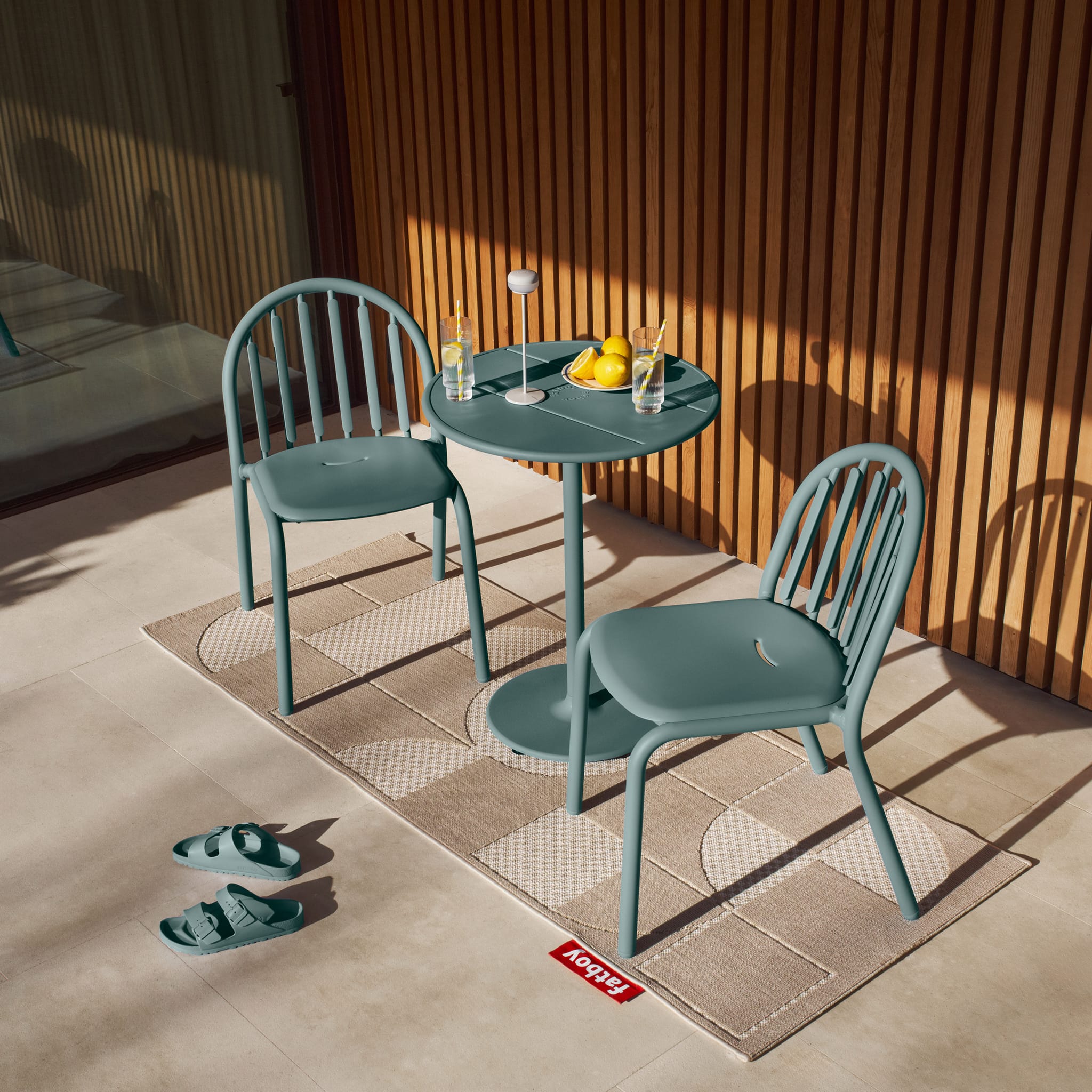 Fred’s Bistreau table with wine glasses, ideal for intimate outdoor dining experiences.
