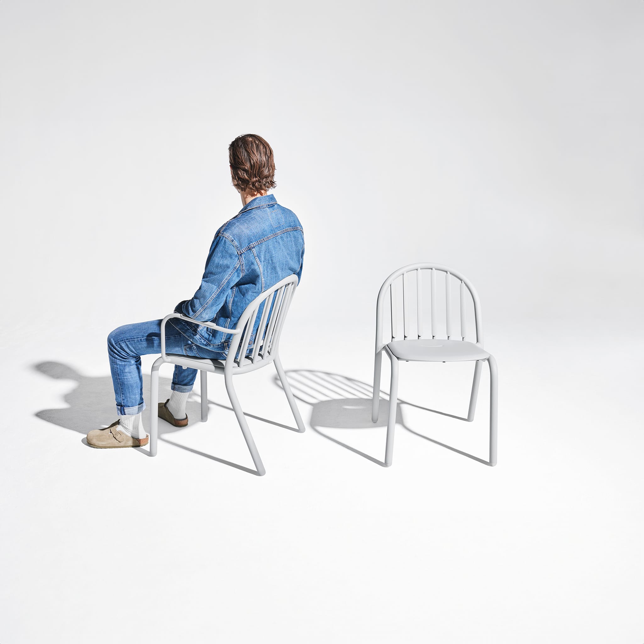 Stacked Fred’s Chairs displayed on a porch, emphasizing their practicality and ease of storage.
