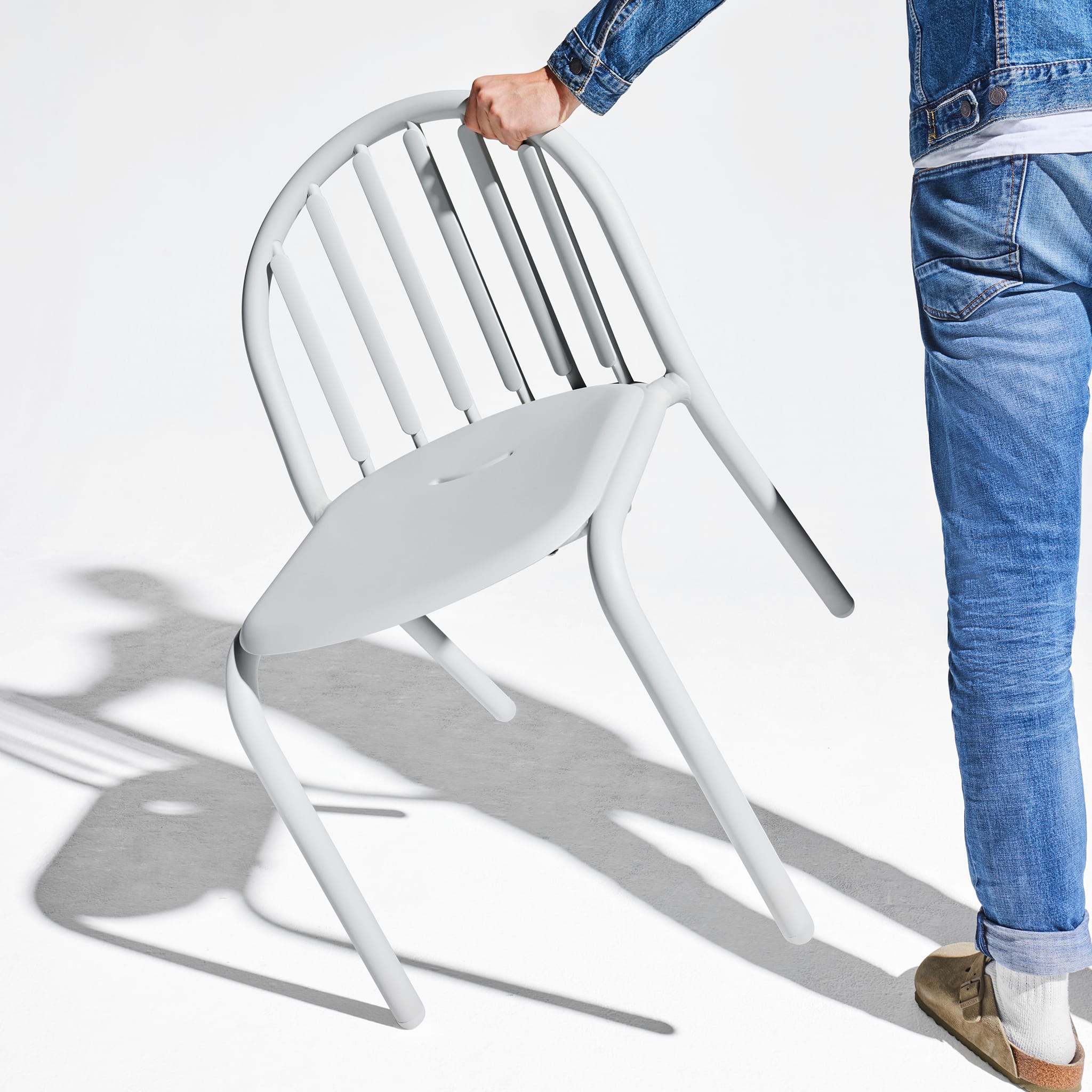 Lightweight Fred’s Chair being moved easily, showcasing its portability and user-friendly design.