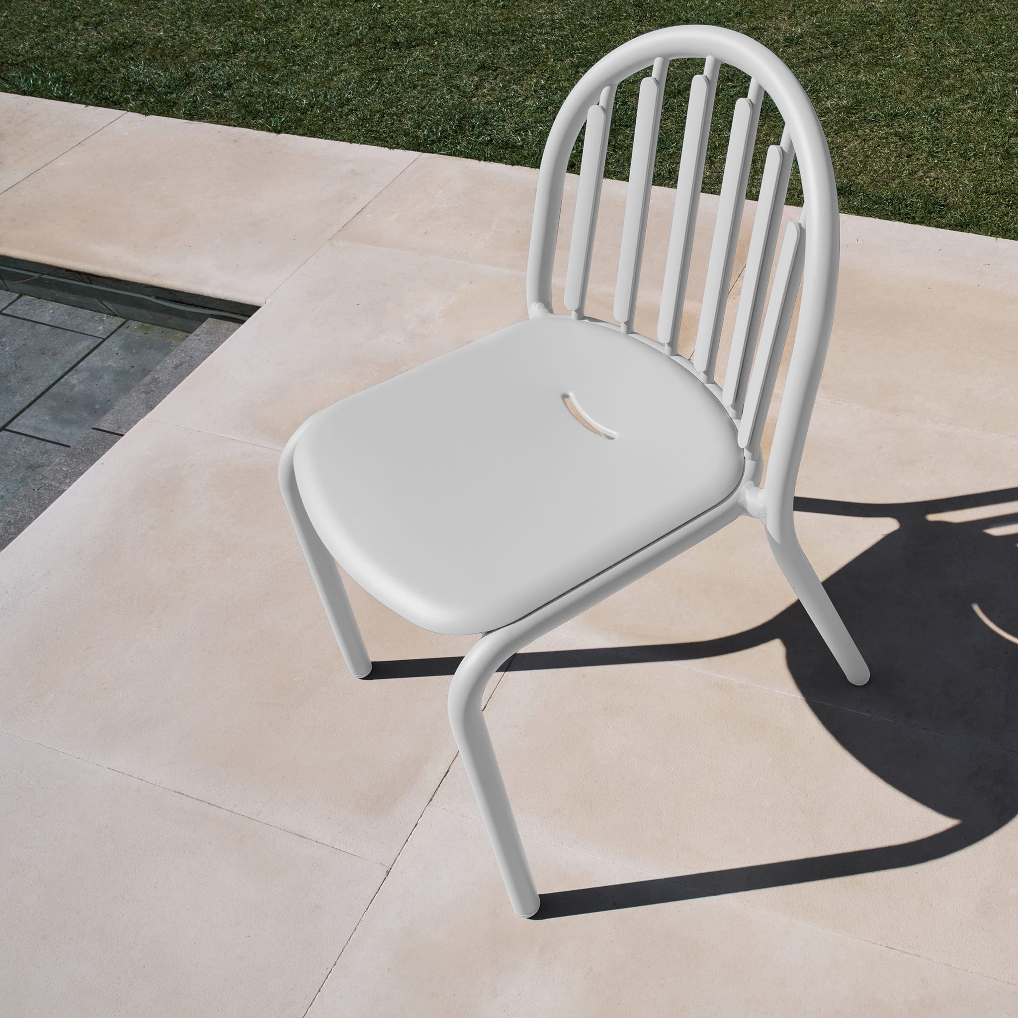 Fred’s Chair on a garden patio, demonstrating its durability and UV-resistant coating against sunlight exposure.