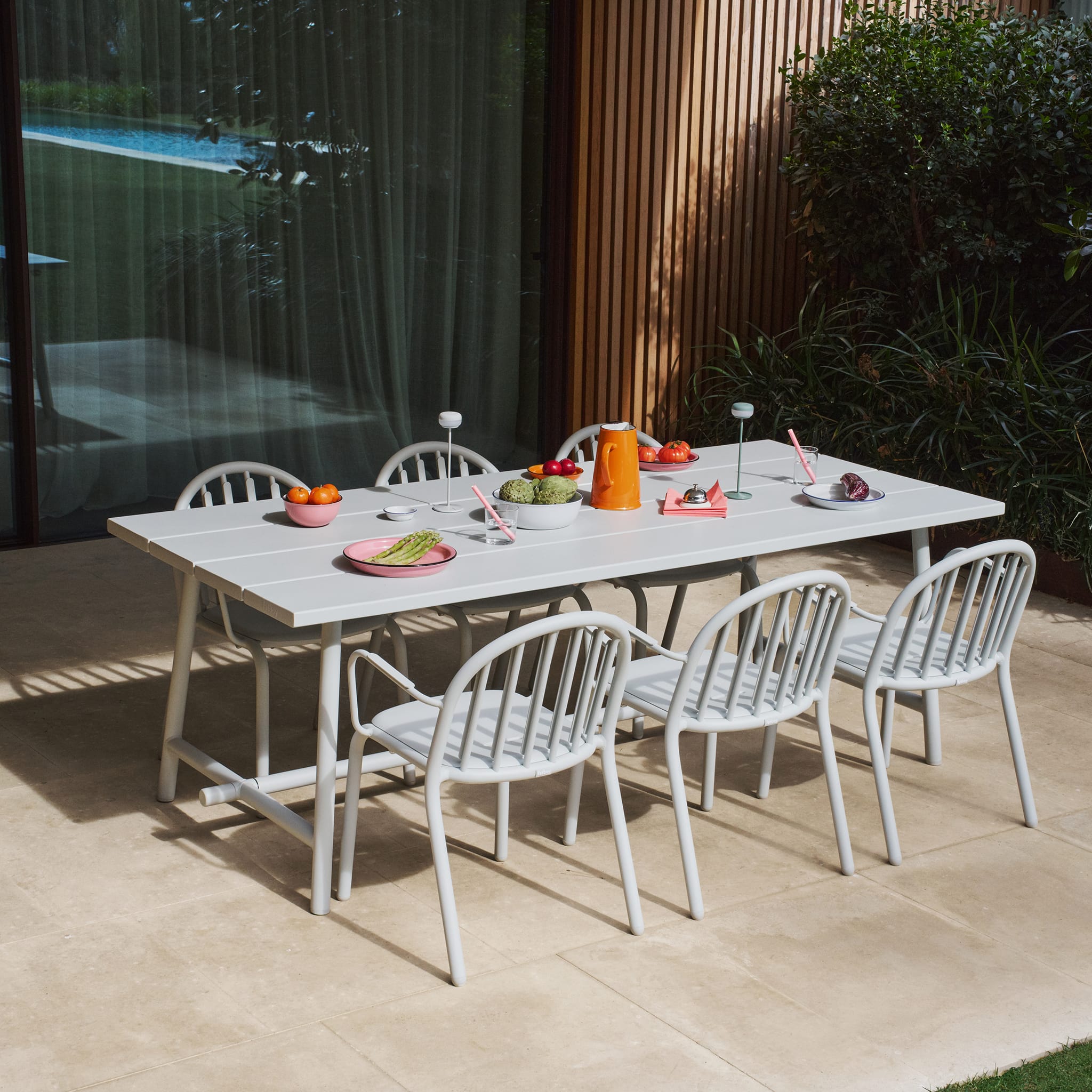 Fred’s Outdoor Table set for a backyard dinner, comfortably seating six to eight people with modern style and stability.