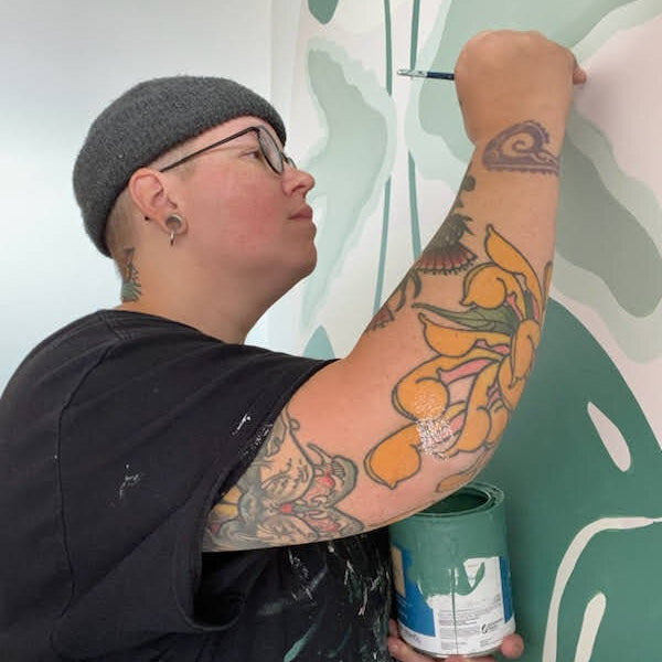 Jo Van painting a mural.