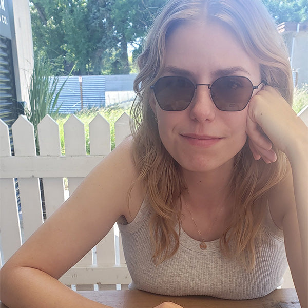 Yonina Rollack sitting on a bench in the sun.