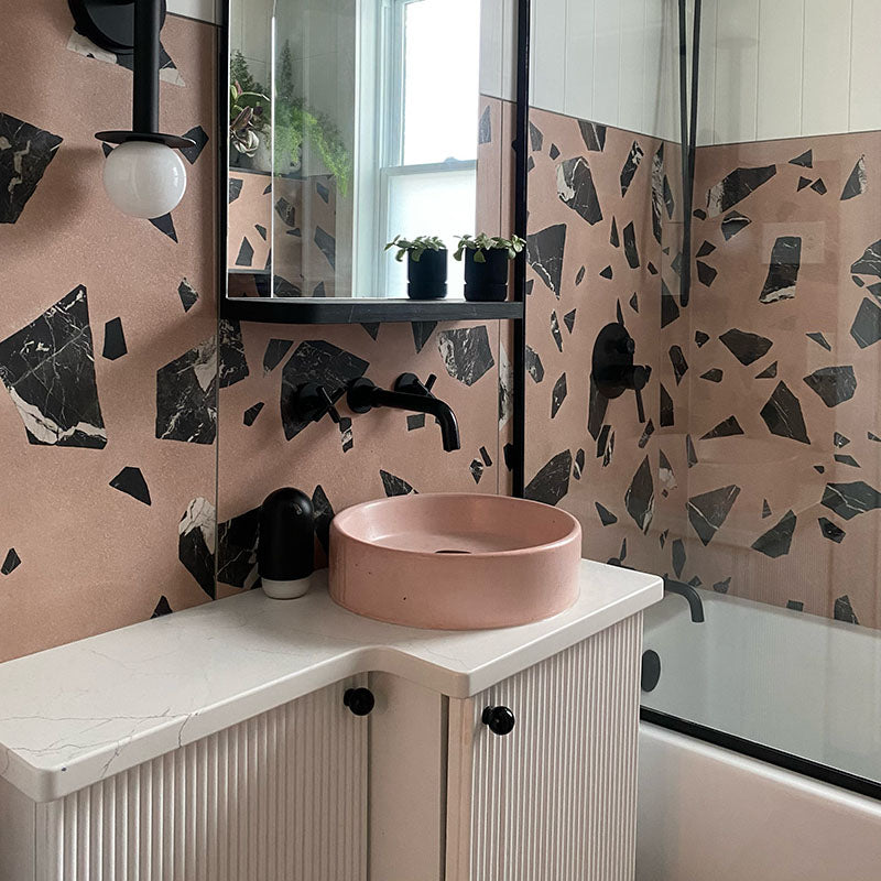 Pink, black, and cream bathroom.