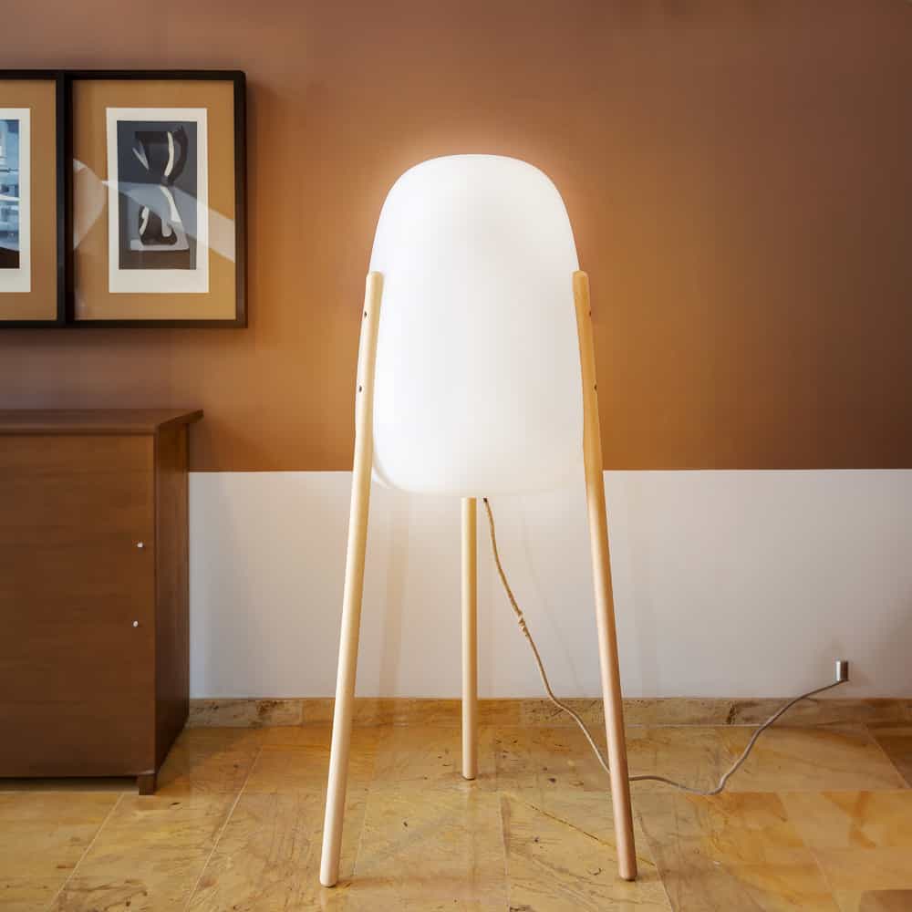 Rocket by Newgarden: A unique floor lamp with wooden legs, perfect for adding a touch of elegance to any space.